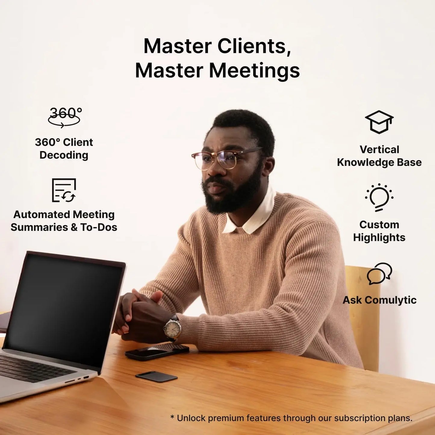 A man with a beard and glasses using the beige comulytic note pro ai voice recorder with headphones jack at a wooden desk