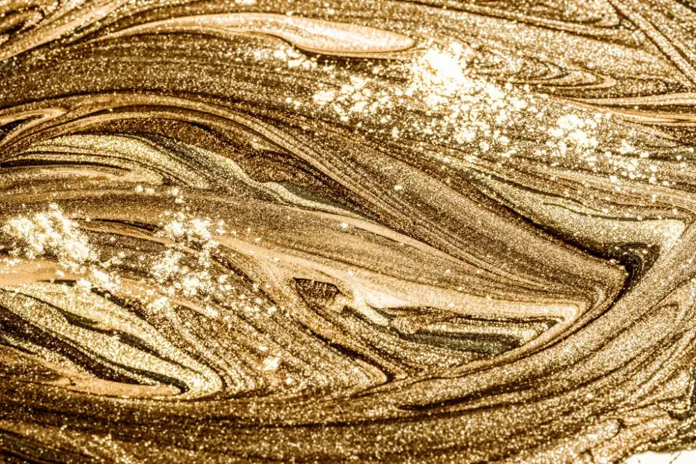 Shimmering gold and bronze metallic paint with swirling, glittery textures.