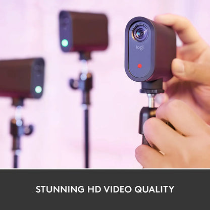 Dark gray logitech mevo start wireless live streaming camera with circular lens and green red indicator lights for video capture